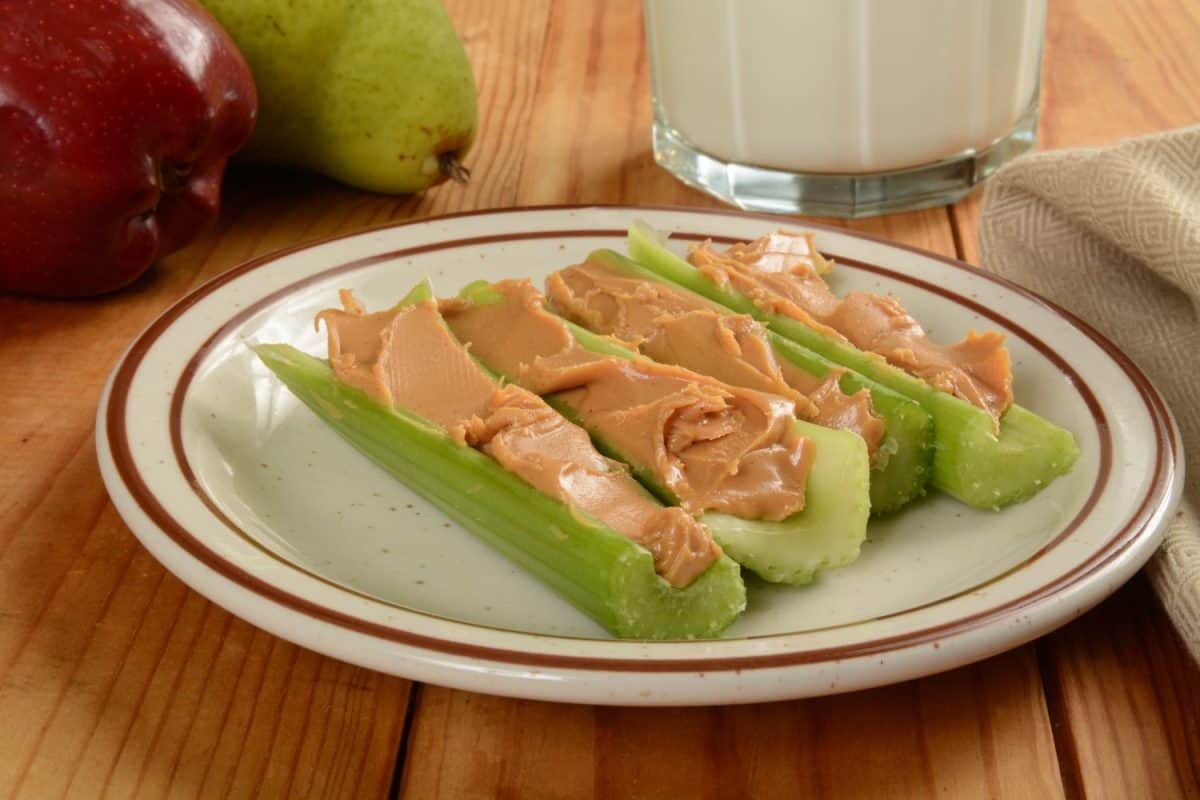 Celery sticks stuffed with organic creamy peanut butter