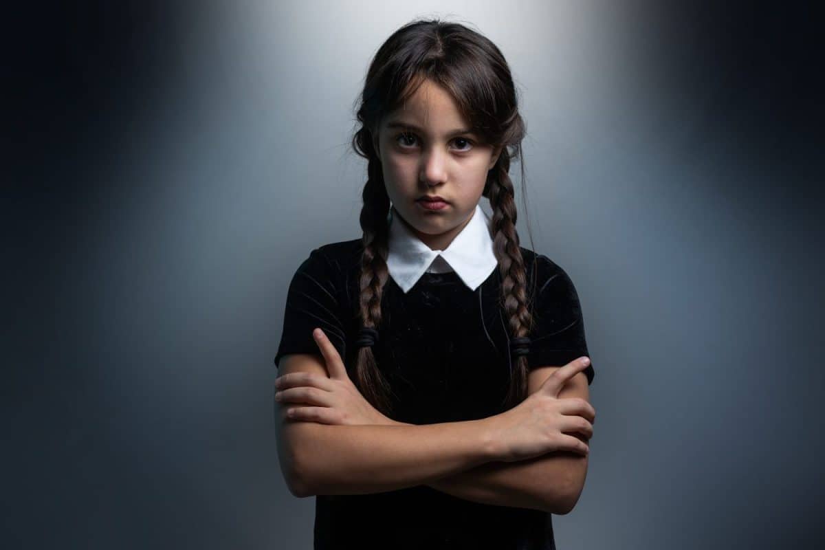 a girl in a Wednesday Addams costume style