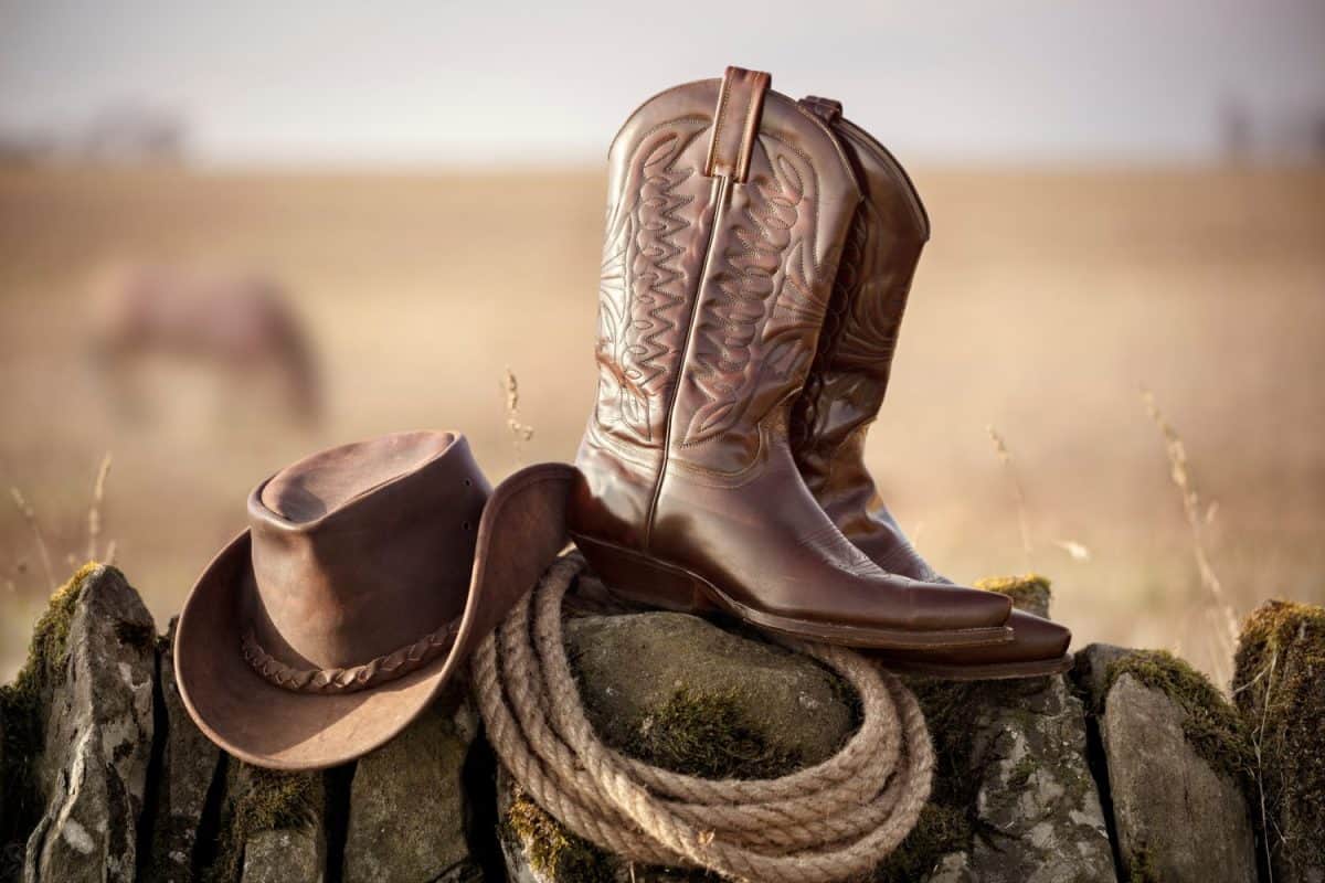 Country music festival live concert with cowboy hat and boots by ranch stables