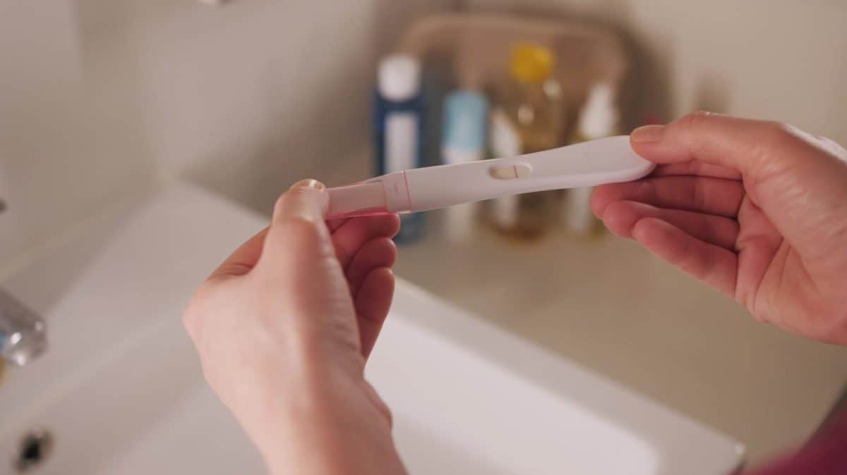 Woman with anxious feelings. Girl with a negative pregnancy test. Close-up of hands holding pregnancy test. These Are the Traits You Got From Your Father