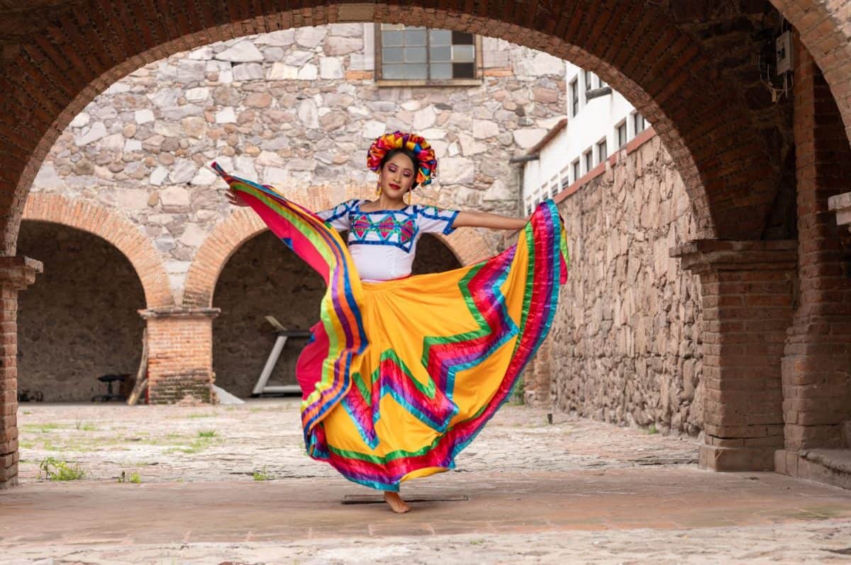 Pretty Young Woman Wearing traditional folkloric dress independence day or cinco de mayo parade or cultural Festival