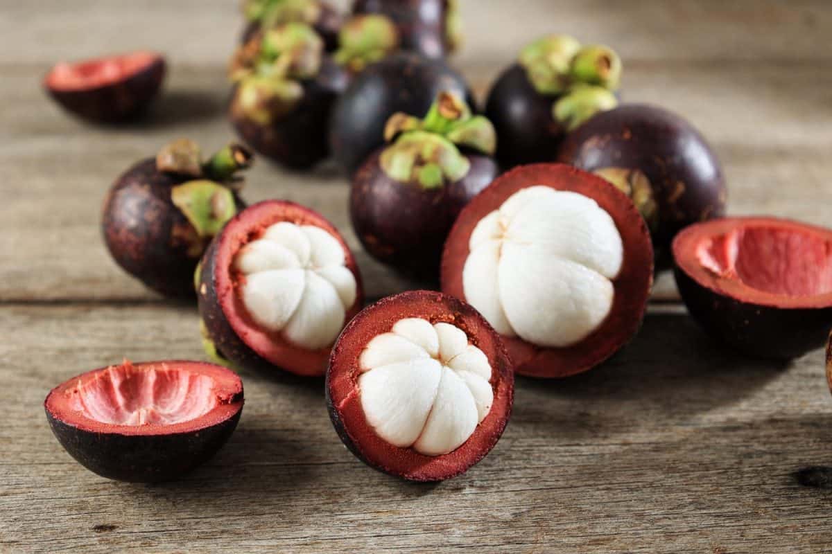 Fresh Mangosteen or Known as The Queen of Fruitson Rustic Wooden Table, Asia Fruits Concept