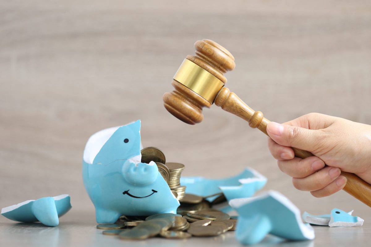 Financial problem, Woman hand holding gavel wooden and broken piggy bank on wooden background,Bankrupt or fail in business concept,poverty