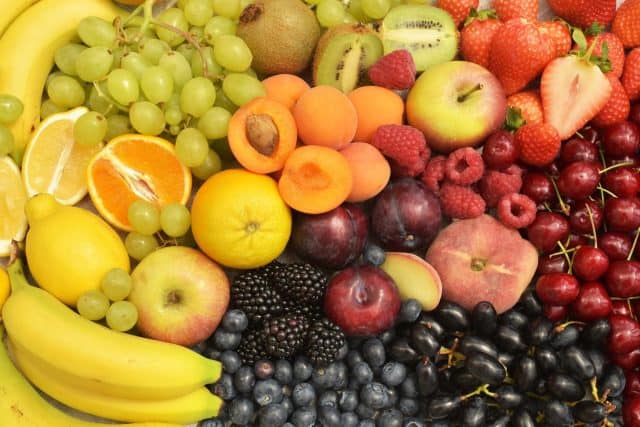 Fresh summer different berries, fruits colourful background. Banana, grapes, cherries, lemon, orange, apricots, apple, blackberries, raspberries, blueberries, strawberries, kiwi, plum. Healthy food.