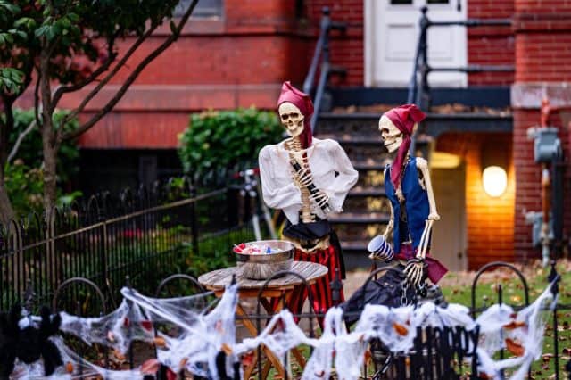 Halloween decor. Halloween pumpkin and skeleton for decorated house. Scary Decorated at front yard of a American home. Trick or treat. Halloween background. Autumn holiday of Halloween.