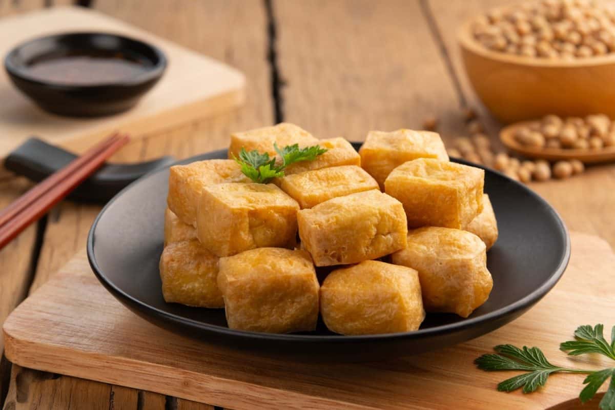 Crispy Air Fryer Tofu,Healthy cooked soybean block tofu used airfryer in black plate with chilli sweet sauce.25 healthy portable snacks to always have on hand