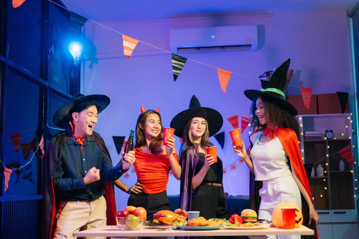 Joyful office Halloween party with coworkers in costumes, celebrating with drinks and laughter, fostering teamwork and festive spirit