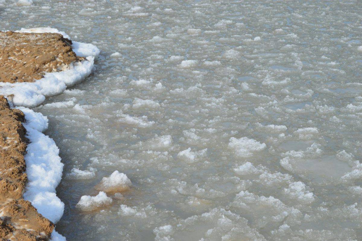 Beautiful view of melting snow and ice along the shore line of lake Huron in Oscoda, Michigan