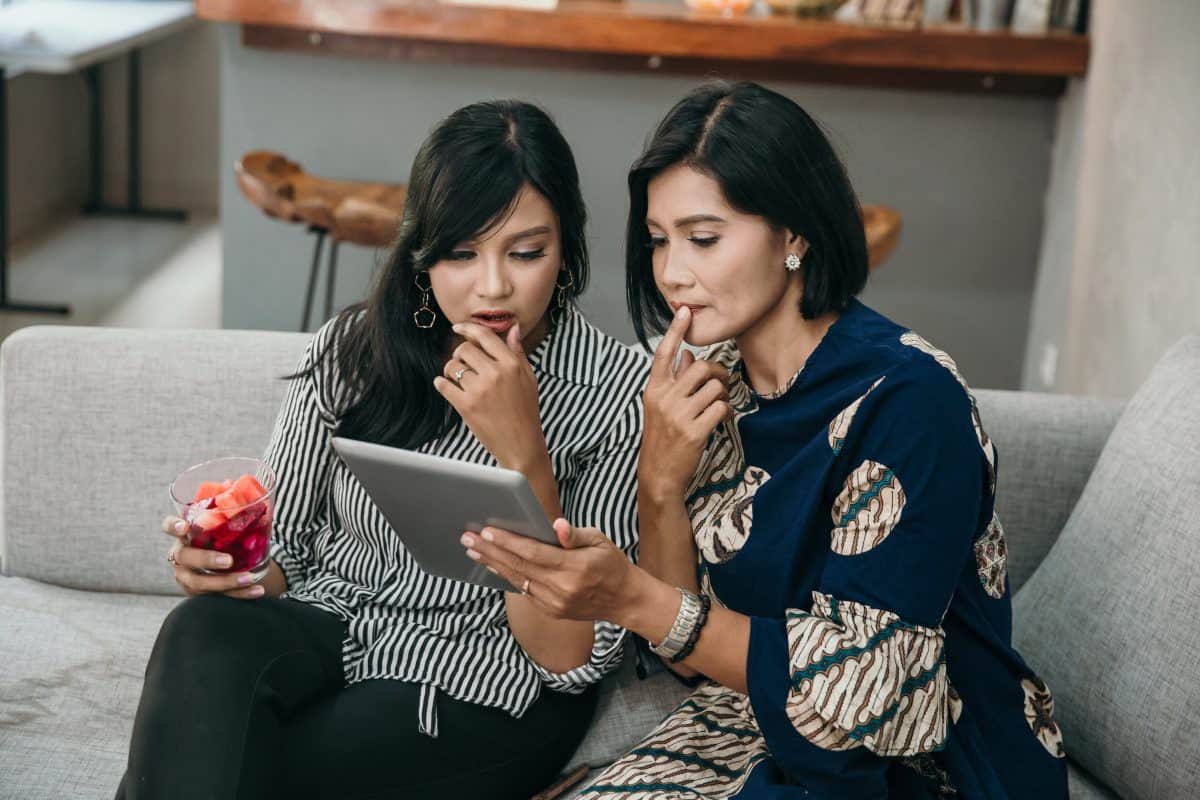 mother and daughter using tablet suprised with the news