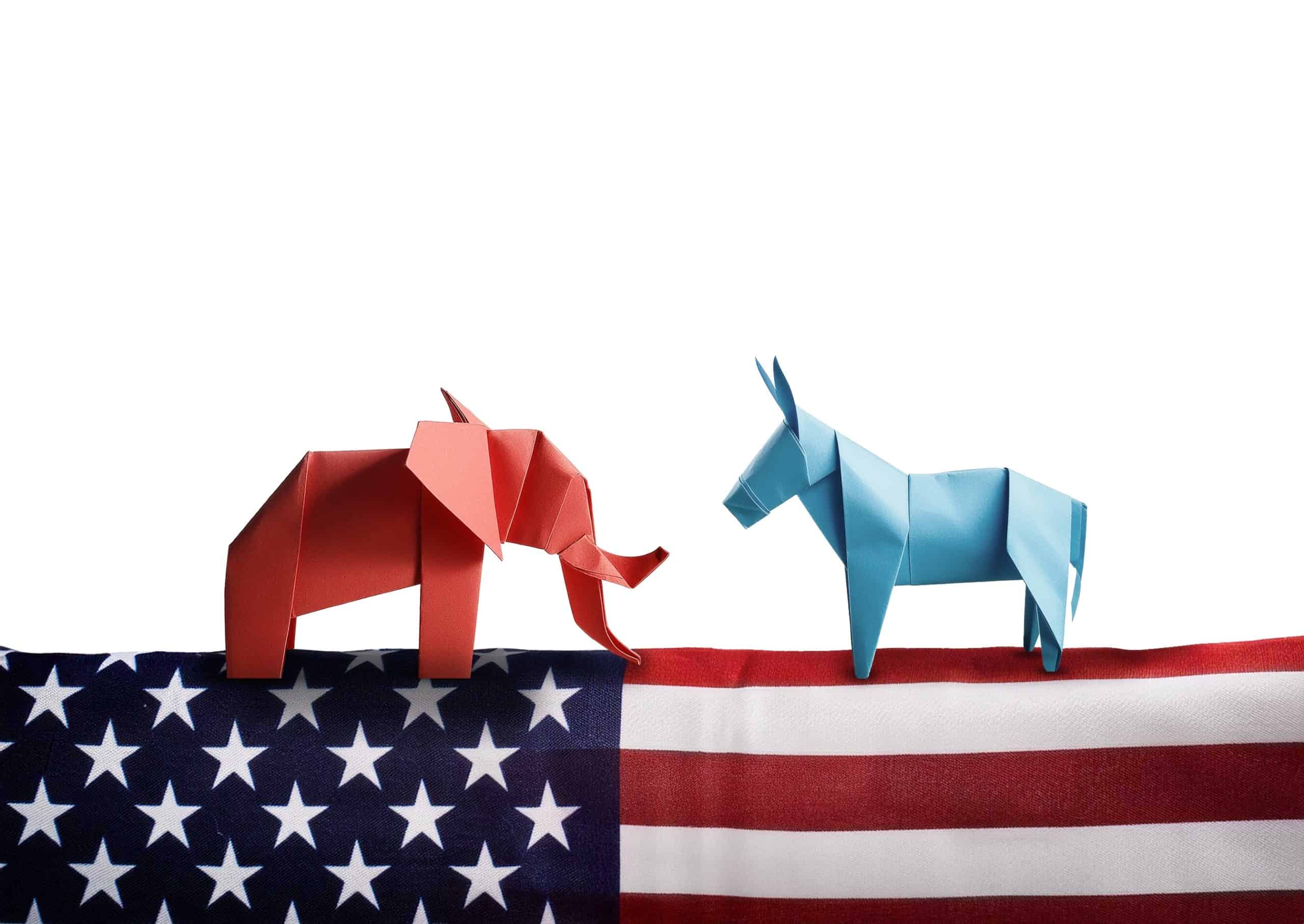 Paper cut out of Democratic Blue Donkey and Republican red elephant over the American flag, origami Political Donkey And Elephant Symbols, American flag, Republican vs Democrat, Election Day, vote