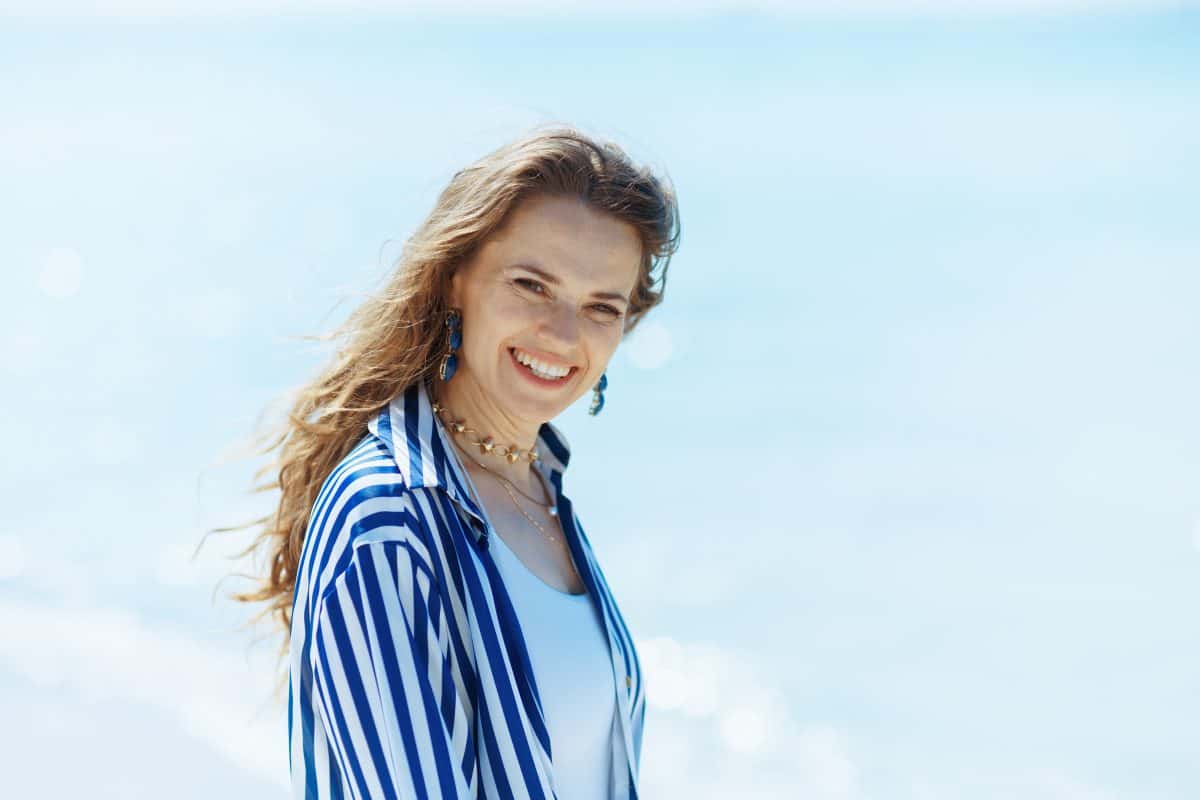 smiling modern woman on the seashore having fun time.