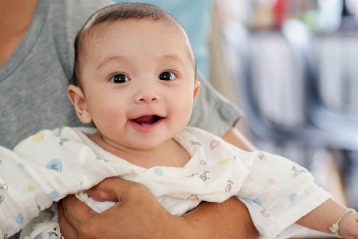 Asian mother and baby son plays at home.