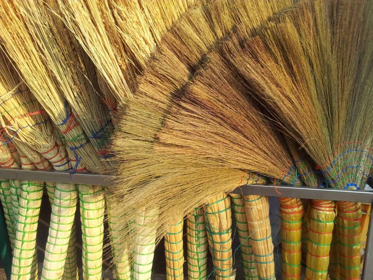 A pile of bamboo brooms in market for sale. Background for texture