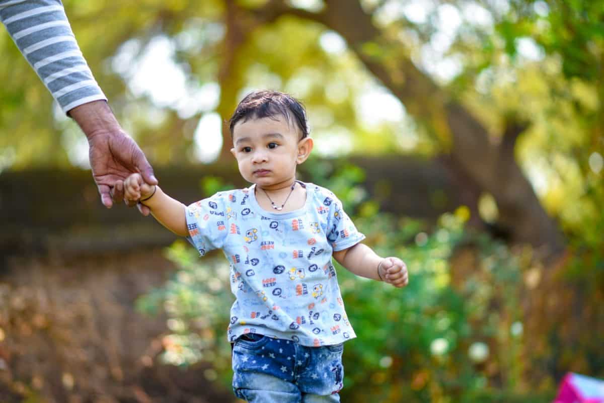 cute indian baby boy playing at garden