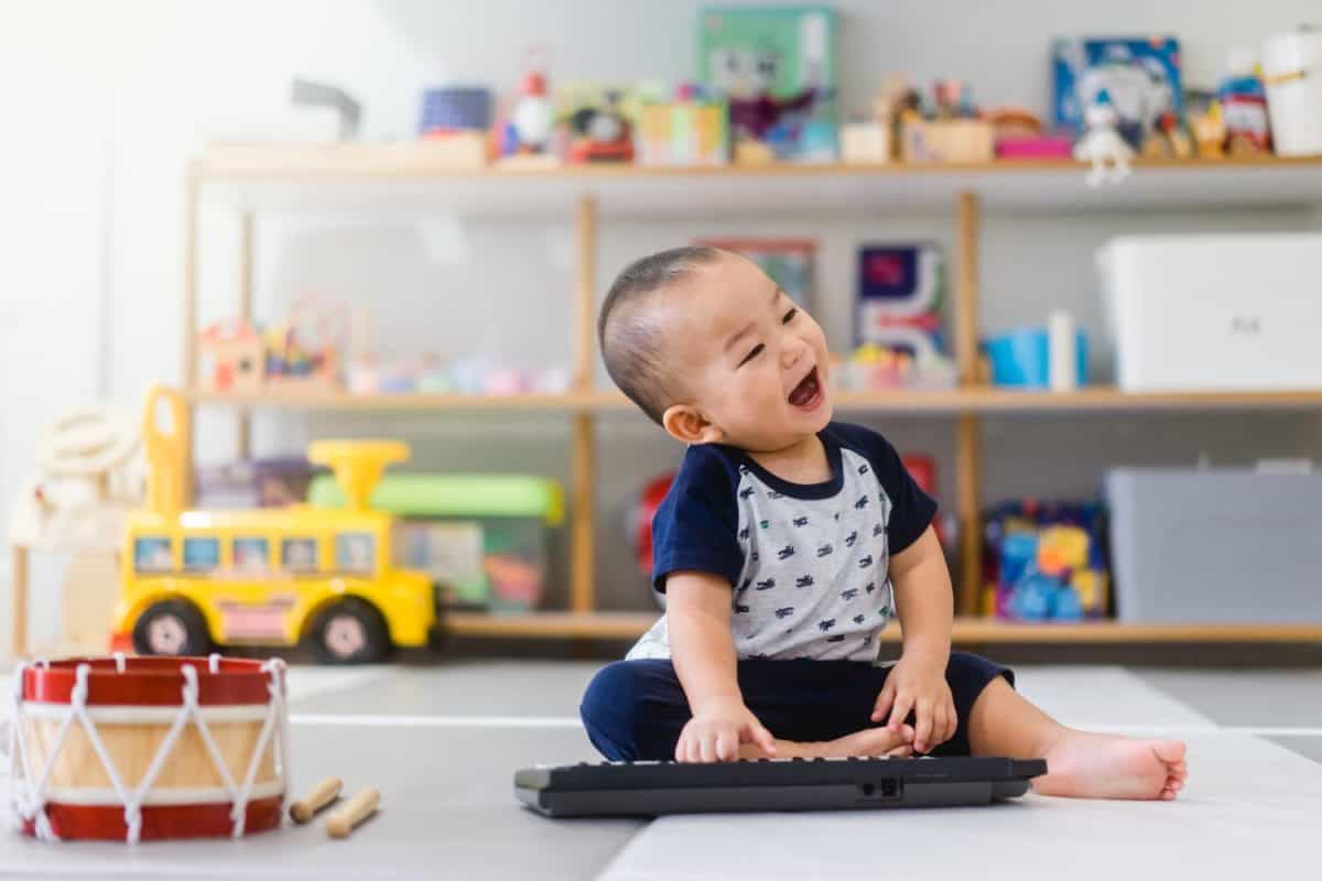 Little baby boy play keyboard and drum at home.Asian boy playing and singing happy moment in music time.