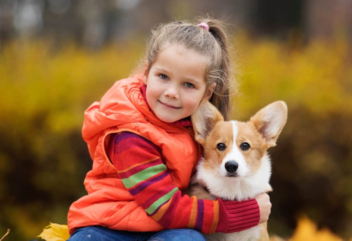 girl hugging a puppy