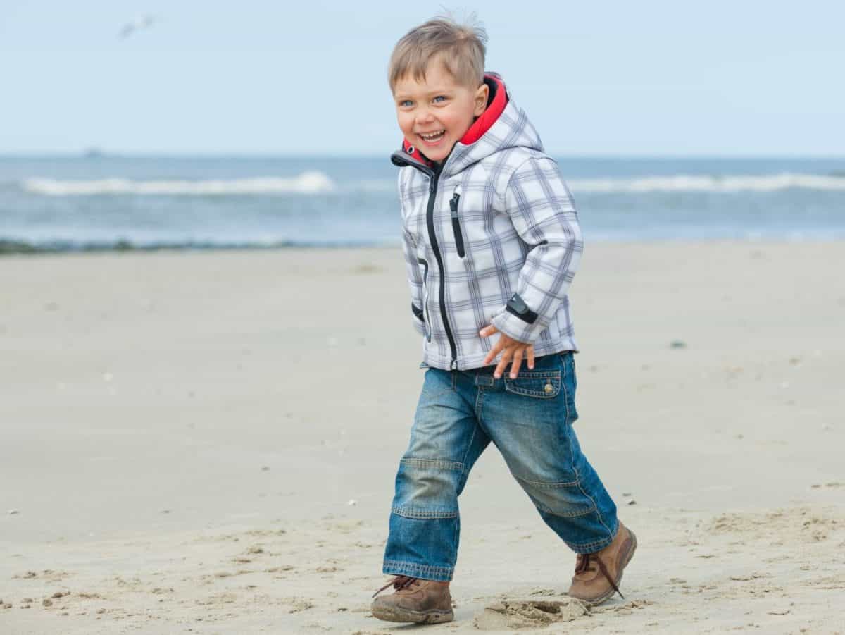 Cute little boy walking on the Dutch beach