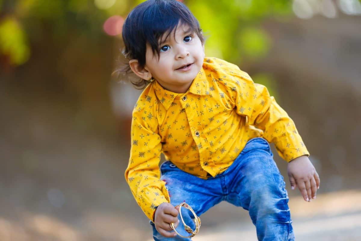 Cute Indian baby boy playing on ground