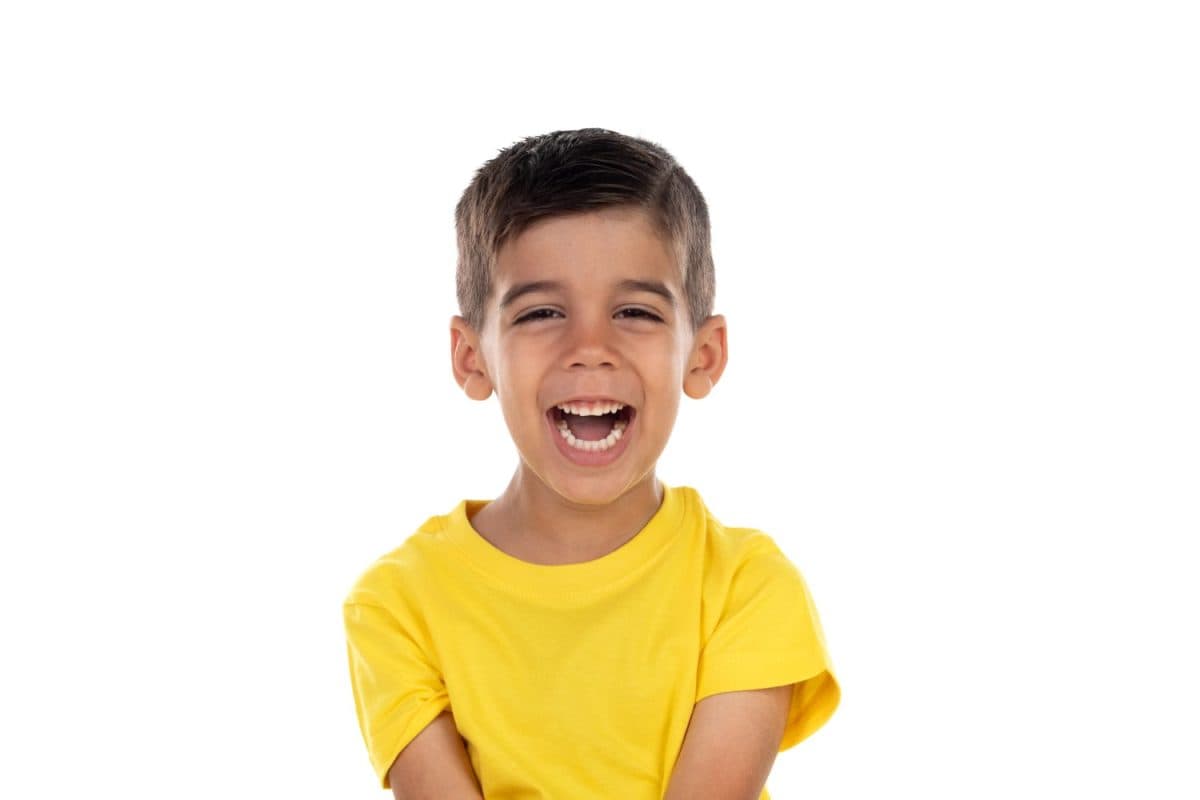 Happy dark child with yellow t-shirt isolated on a white background