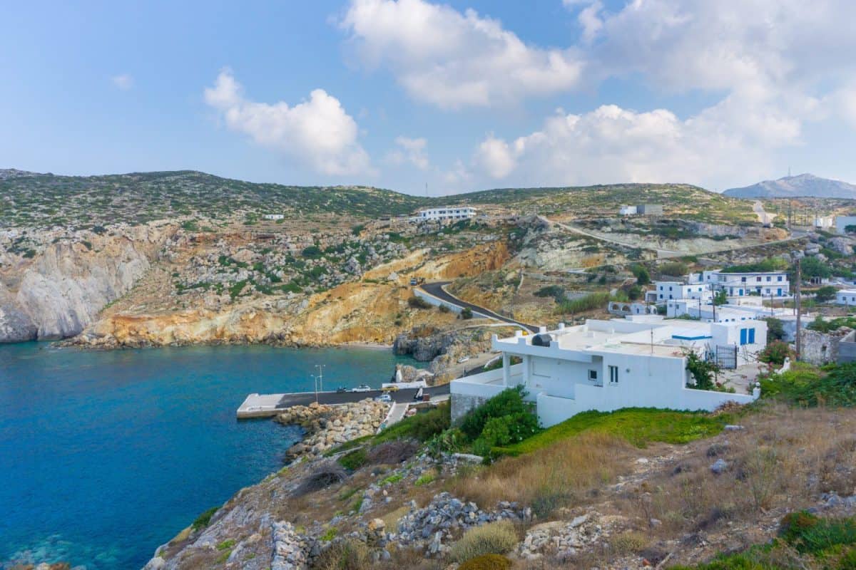 Potamos village with the port and the traditional white houses with blue windows in Antikythera island in Greece