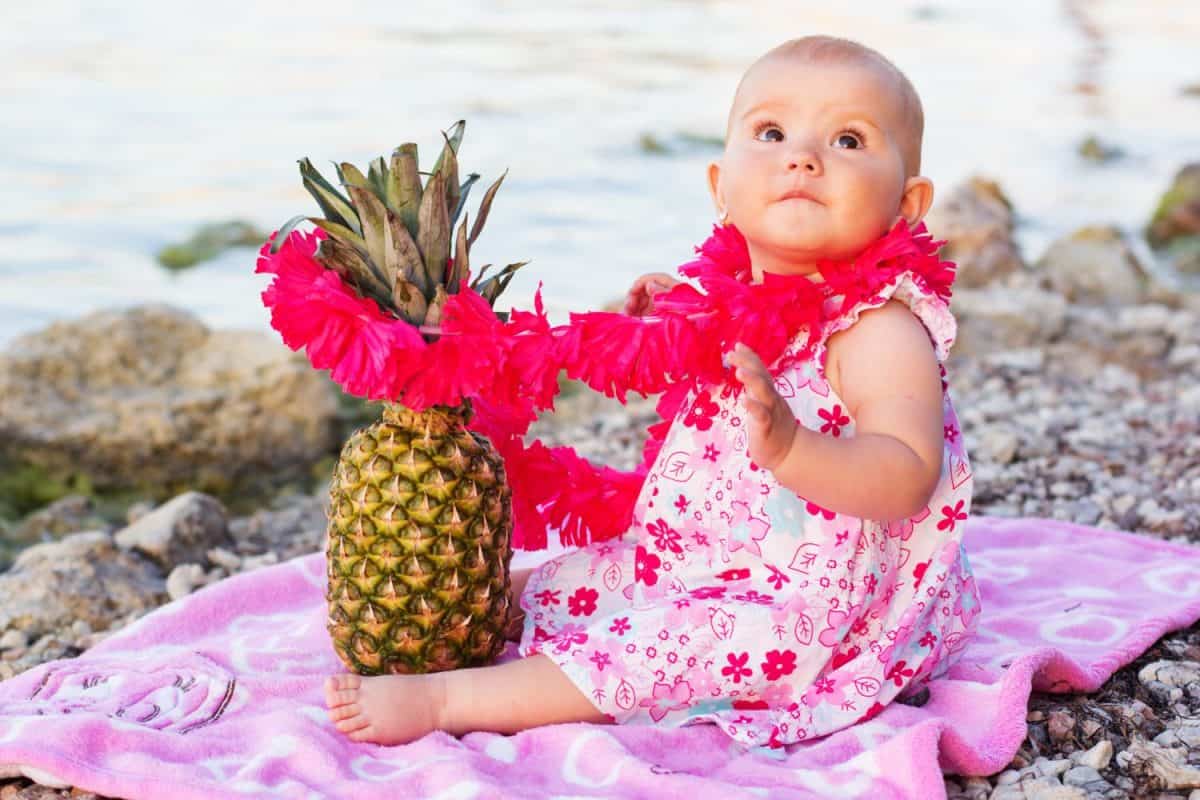 Little baby girl resting on the beach