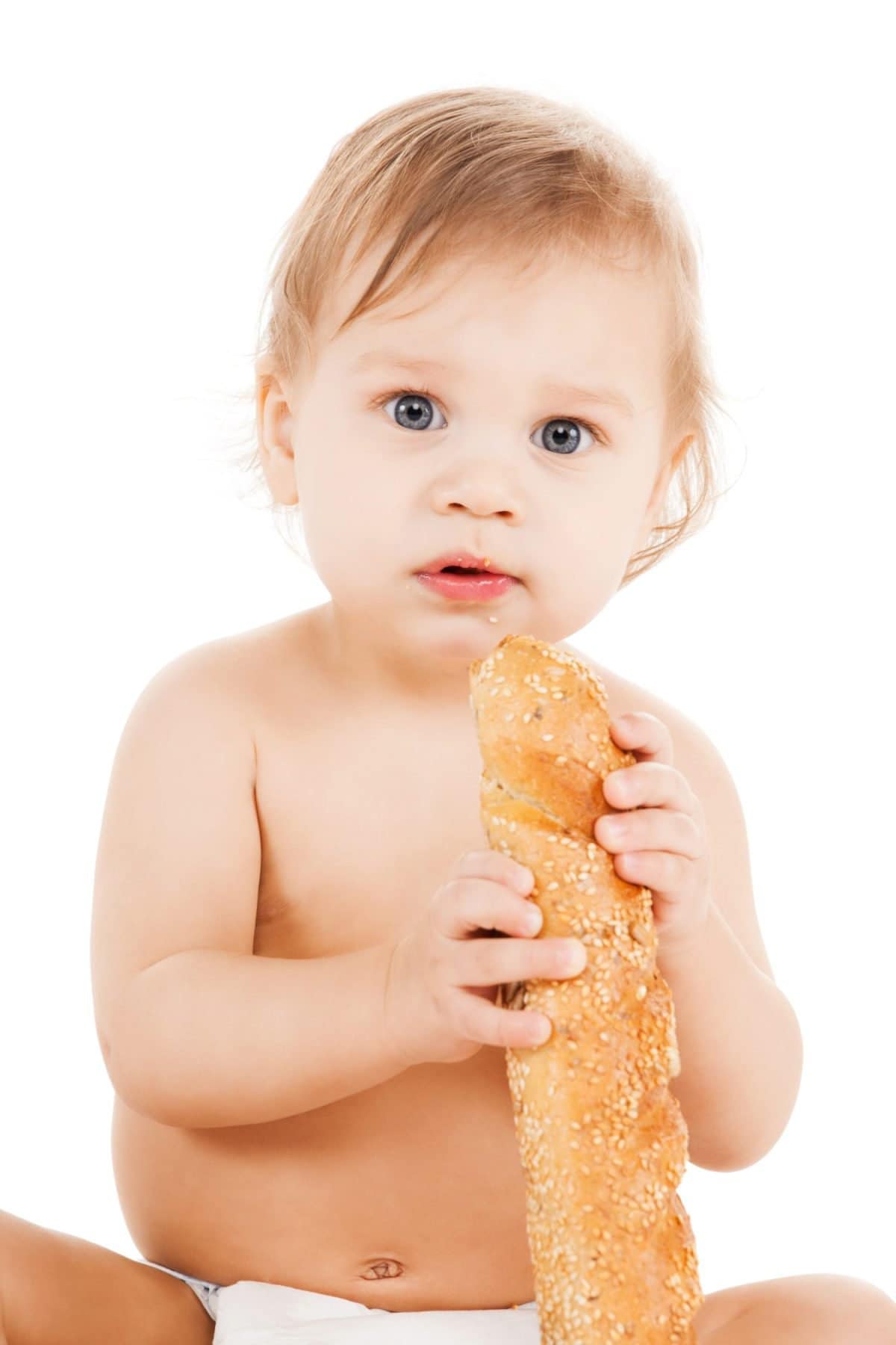 childhood and food concept - cute todler eating long bread