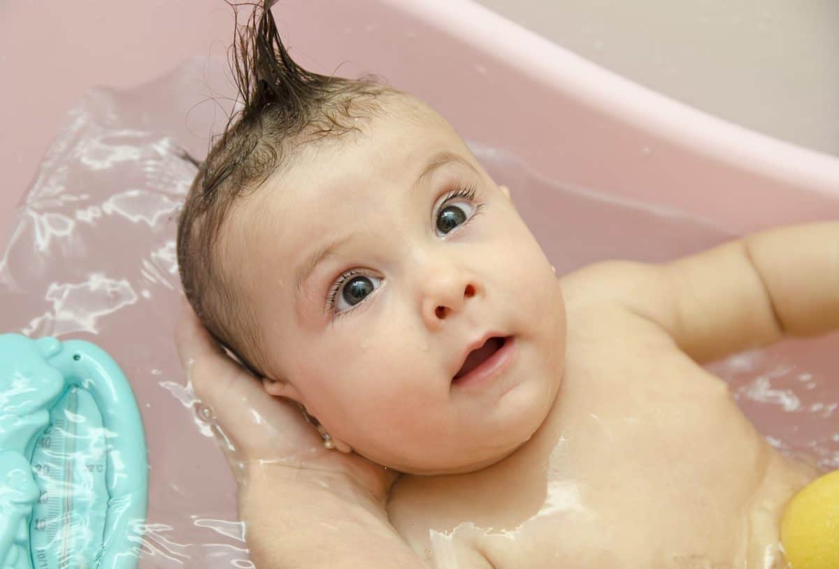 Cleaning baby in bathtub