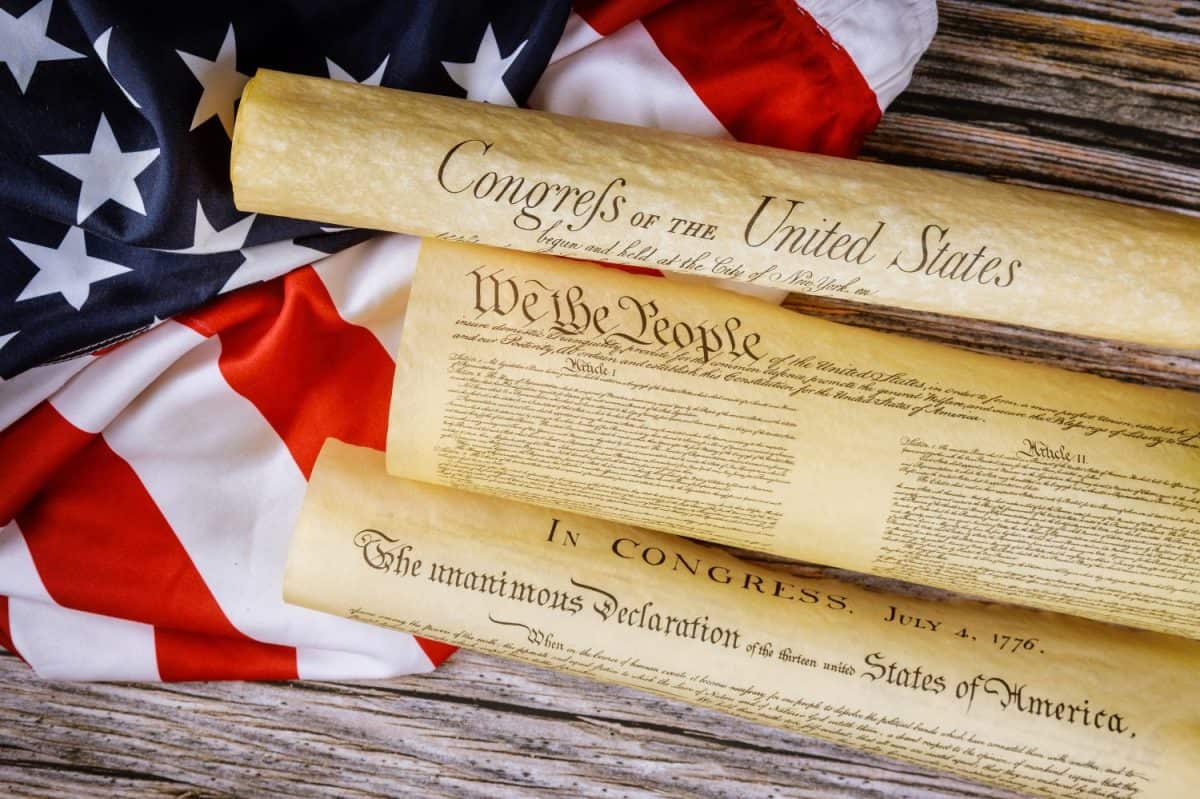 Closeup of a replica of U.S. document of American constitution We the people with USA Flag.