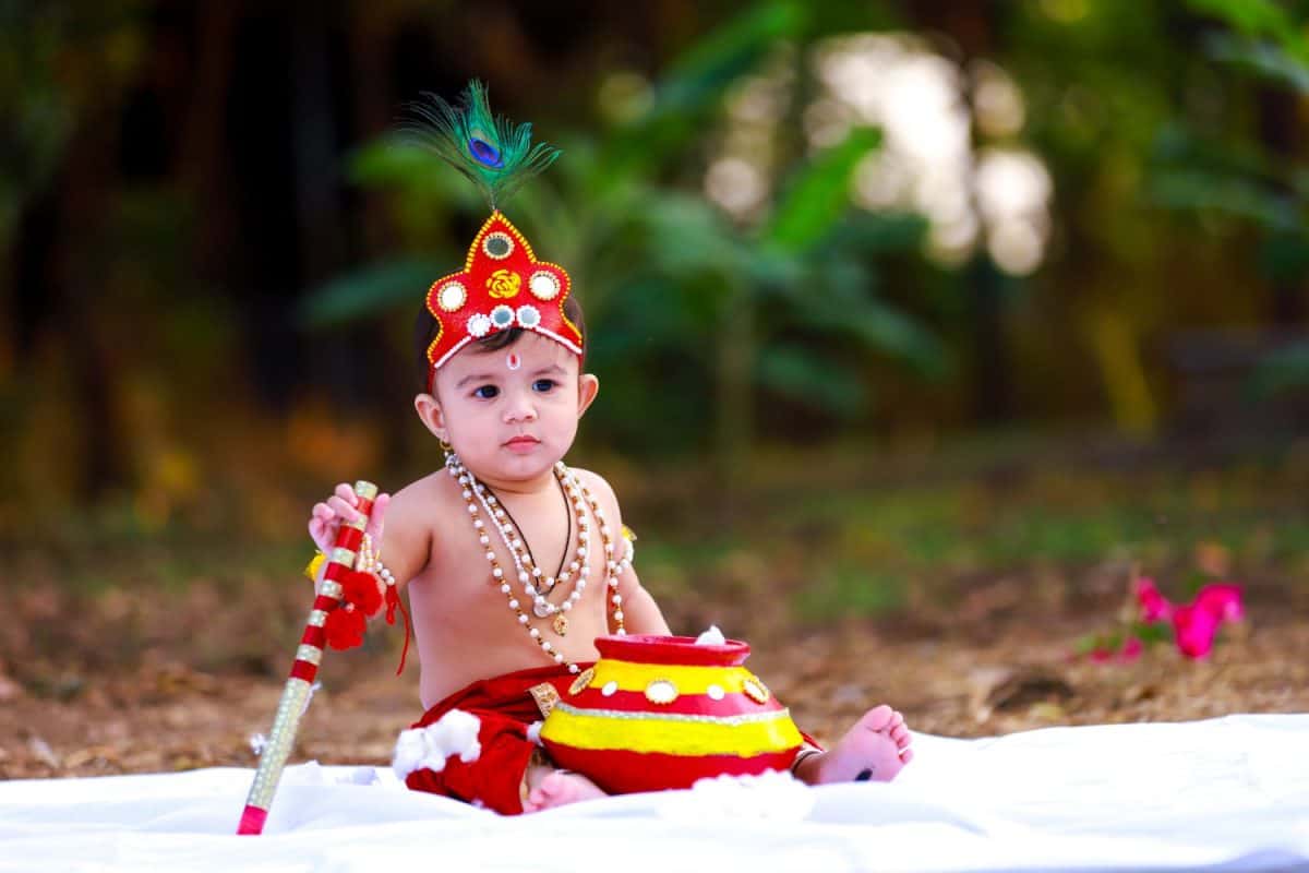 Adorable crawling baby wearing Krishna costume. India 04-feb-2020