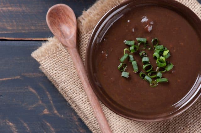 Delicious dish of Brazilian cuisine called Caldo de Feijão. Made with black beans, bacon and sausage. Bean broth.