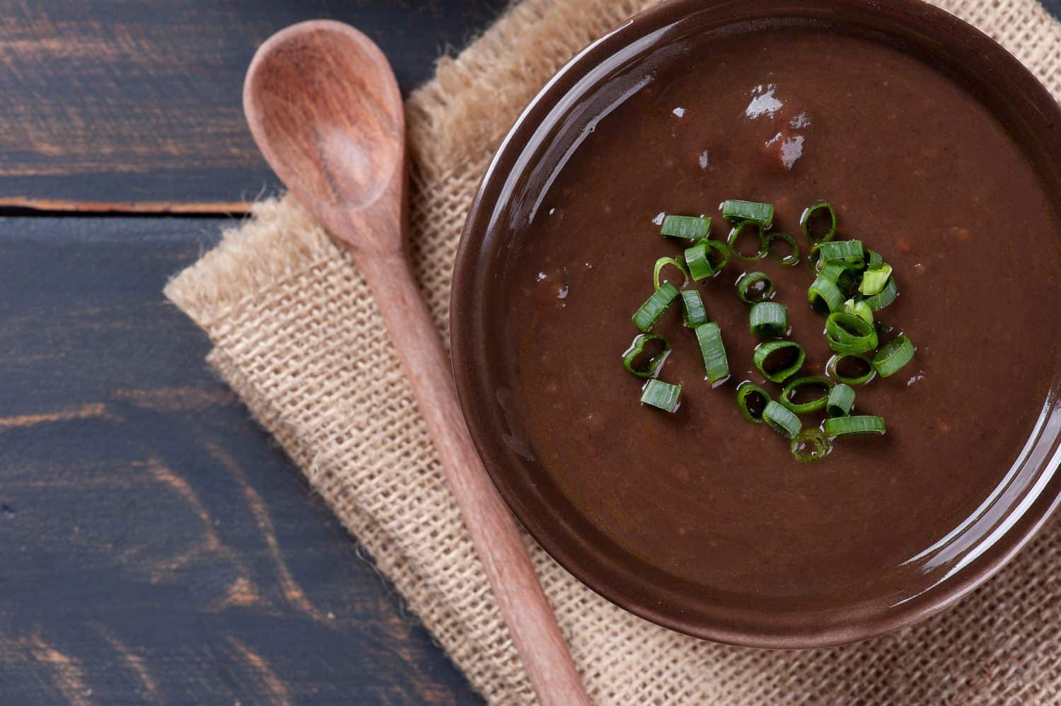 Delicious dish of Brazilian cuisine called Caldo de Feijão. Made with black beans, bacon and sausage. Bean broth.