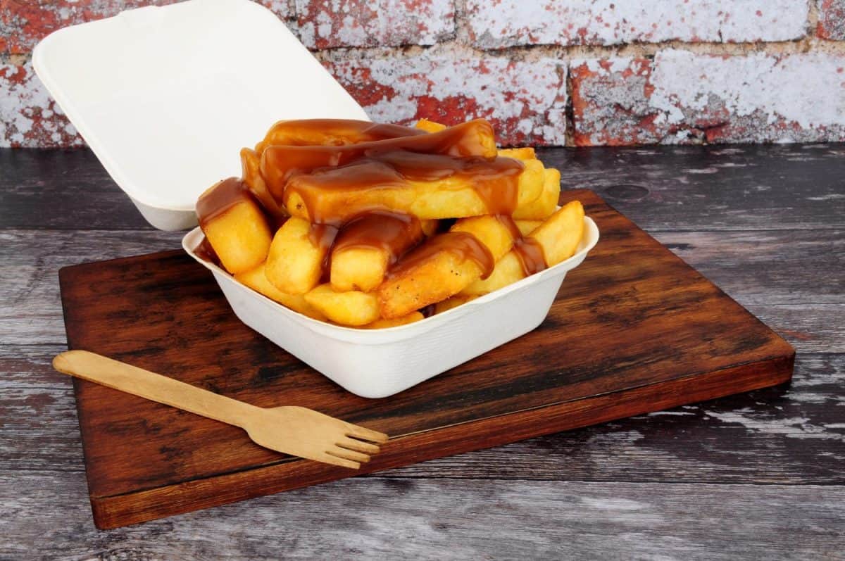 Chips and gravy meal in a take away box with lid. household routine