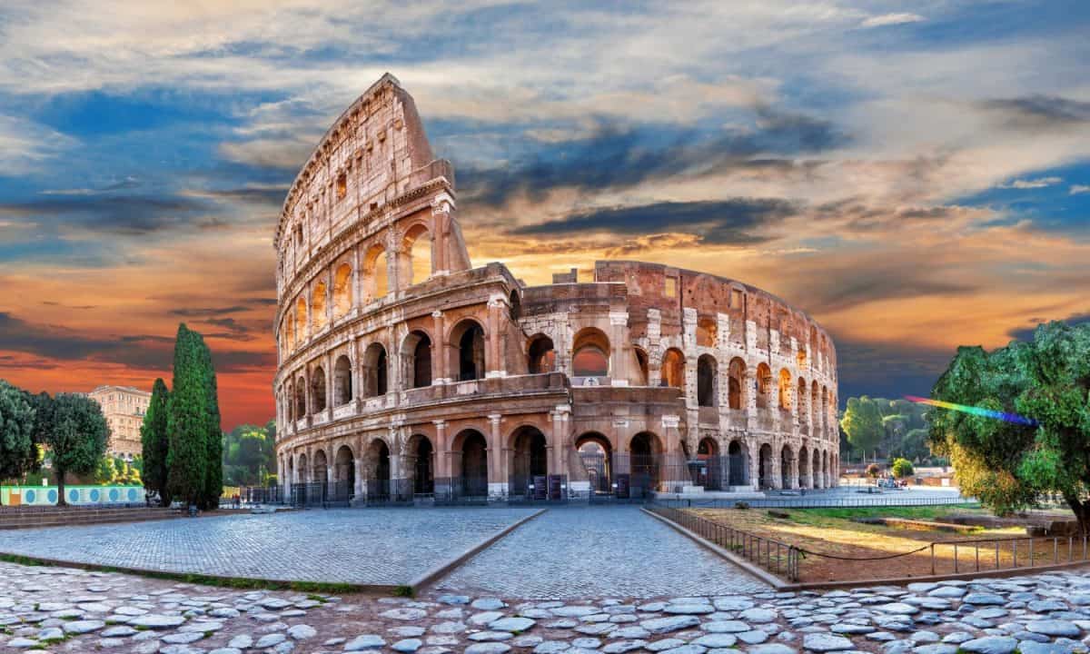 Roman Coliseum at sunset, summer view under the clouds, Italy