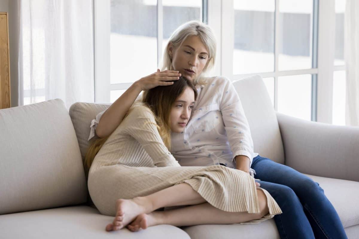 Loving mum stroking her frustrated pre-teen daughter, give emotional support, feeling empathy, give advice, having good trustful relationship between teenager and parent. Adolescence problems, care