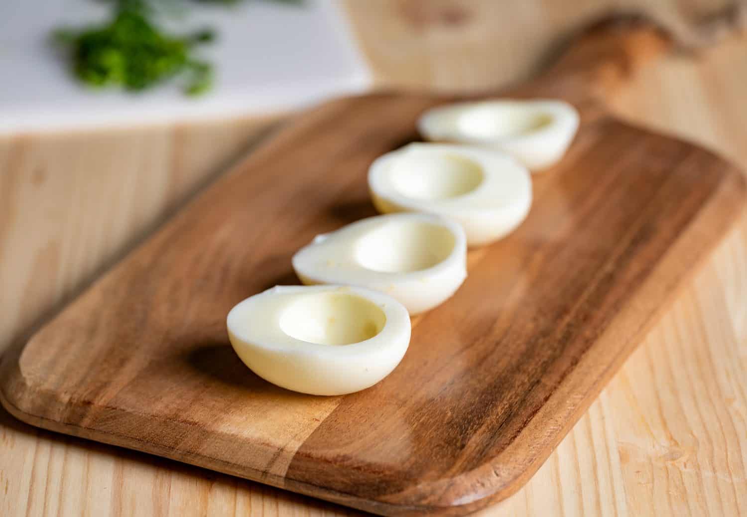 Empty hard boiled egg halves waiting to be filled with deviled egg mixture