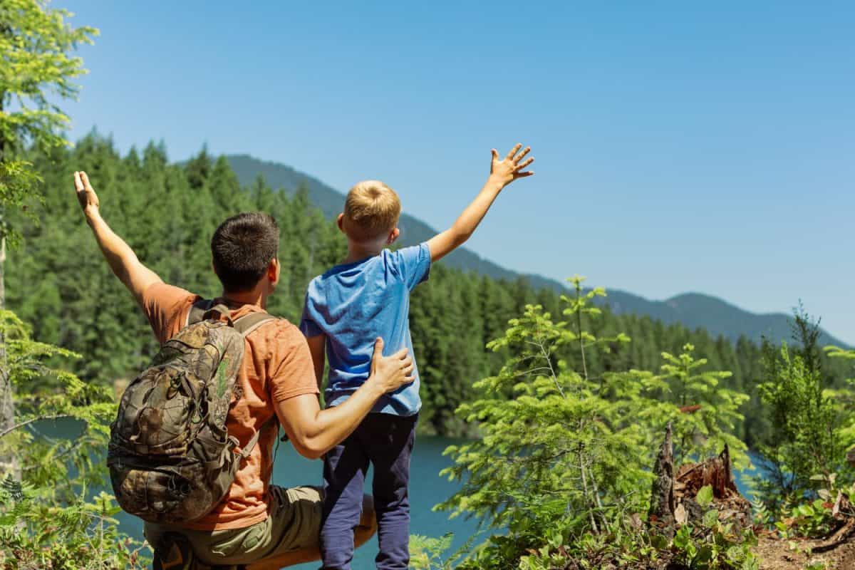 Father son parent child travel in mountains, family hiking summer holiday