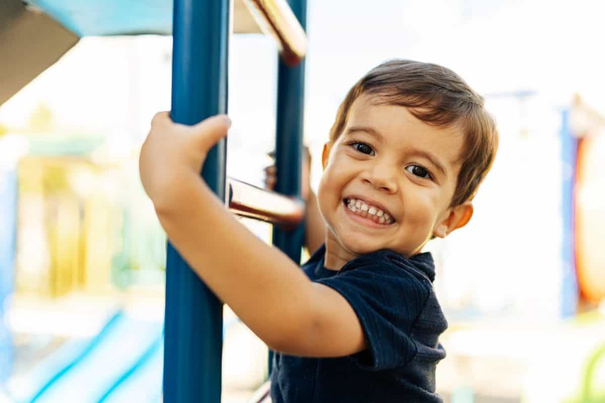 Adorable Brazilian boy playing at the park