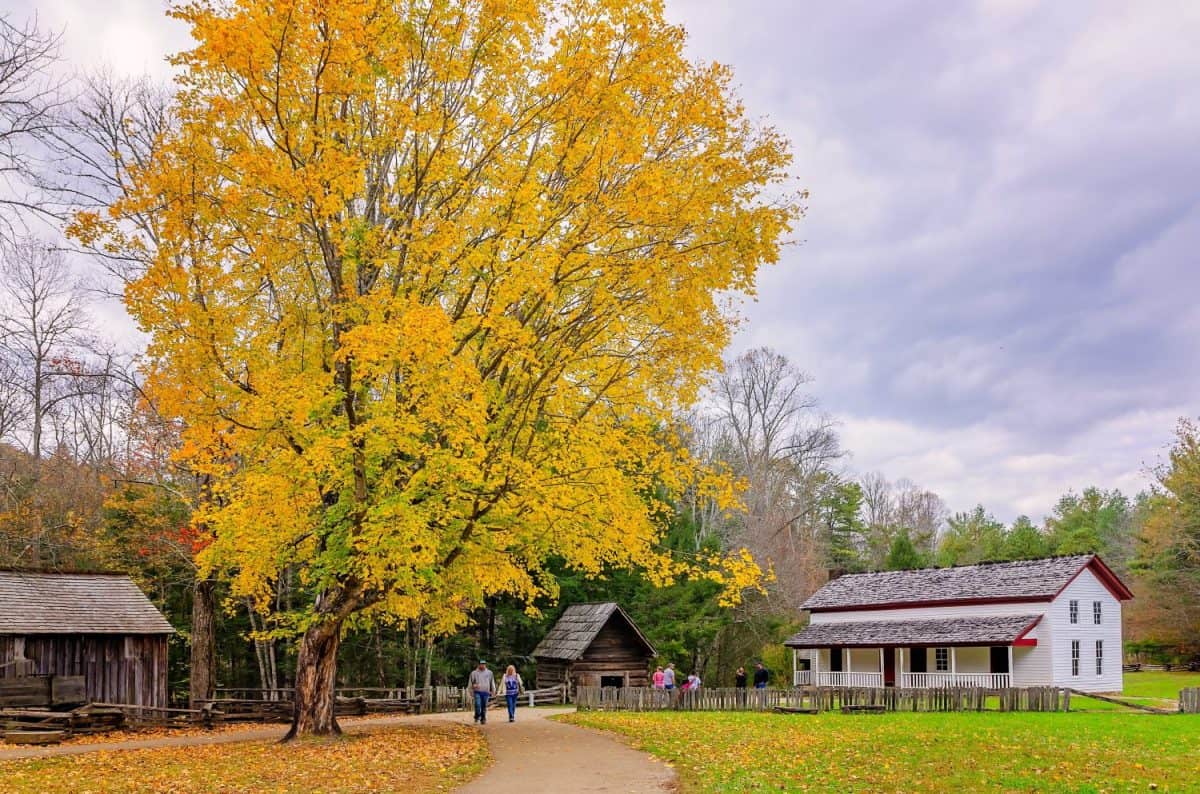 Townsend, Tennessee, USA - Nov. 2, 2017: A couple walks past the Gregg-Cable House at the John P. Cable Mill Complex in Great Smoky Mountains National Park.