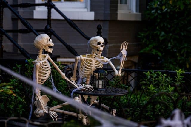 Halloween concept. Halloween pumpkin and skeleton for decorated house. Scary Decorated at front yard of a American home. Trick or treat. Halloween background. Autumn holiday of Halloween.