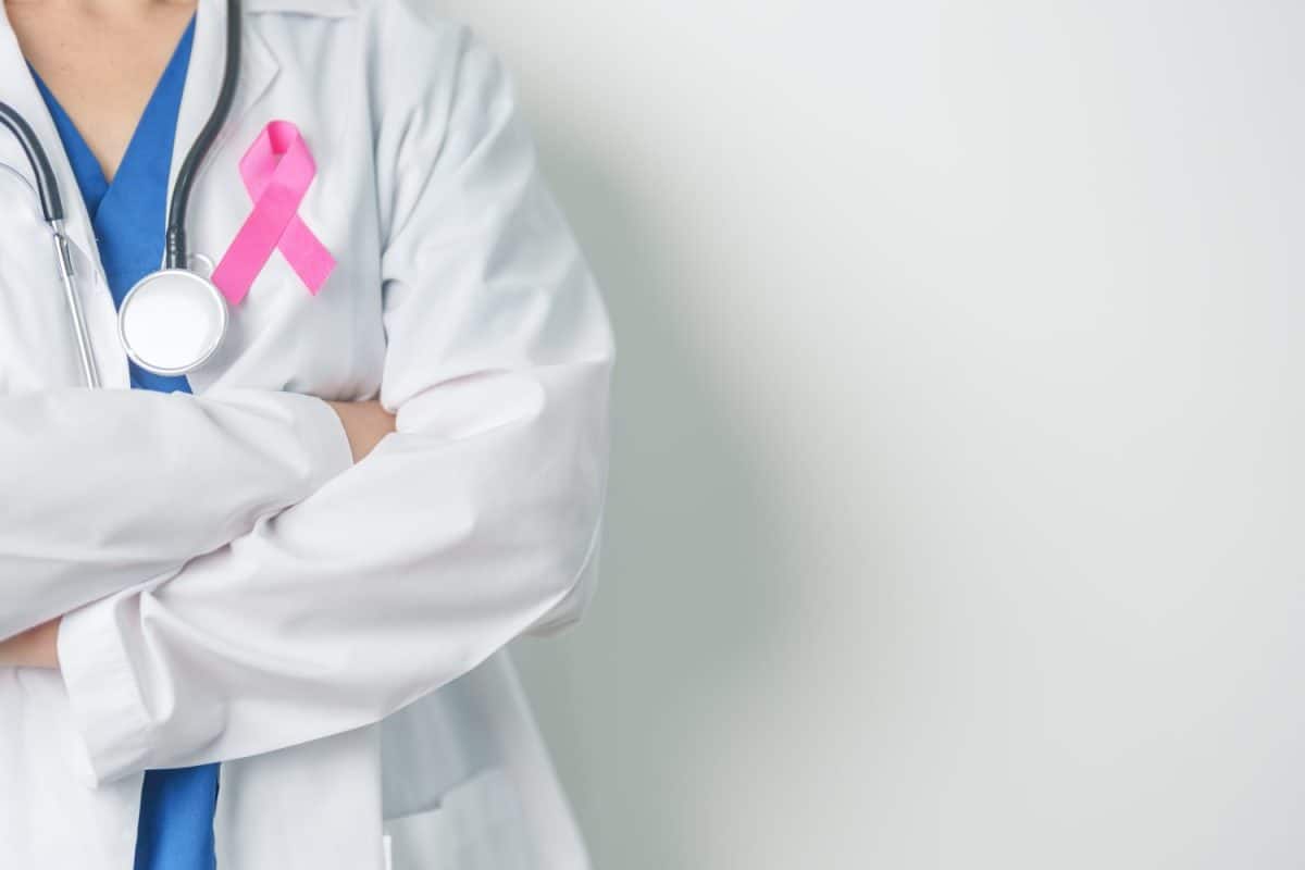 Pink October Breast Cancer Awareness month, woman doctor with pink Ribbon in hospital for support people life and illness. National cancer survivors month, Mother and World cancer day concept