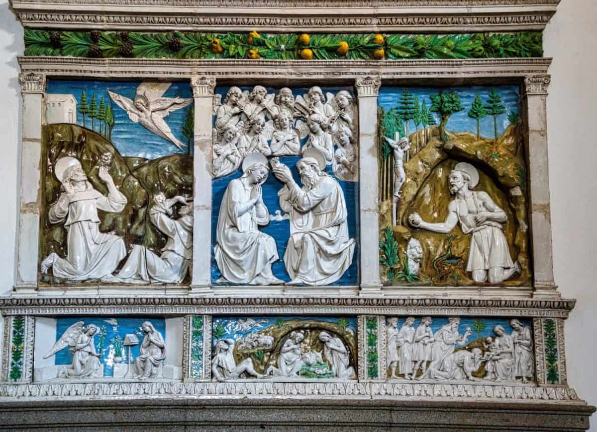 Glazed terracotta altarpiece by the master Luca della Robbia. Work of the early Renaissance 14th century in the parish church of Saints Flora and Lucilla in Santa Fiora Tuscany Italy