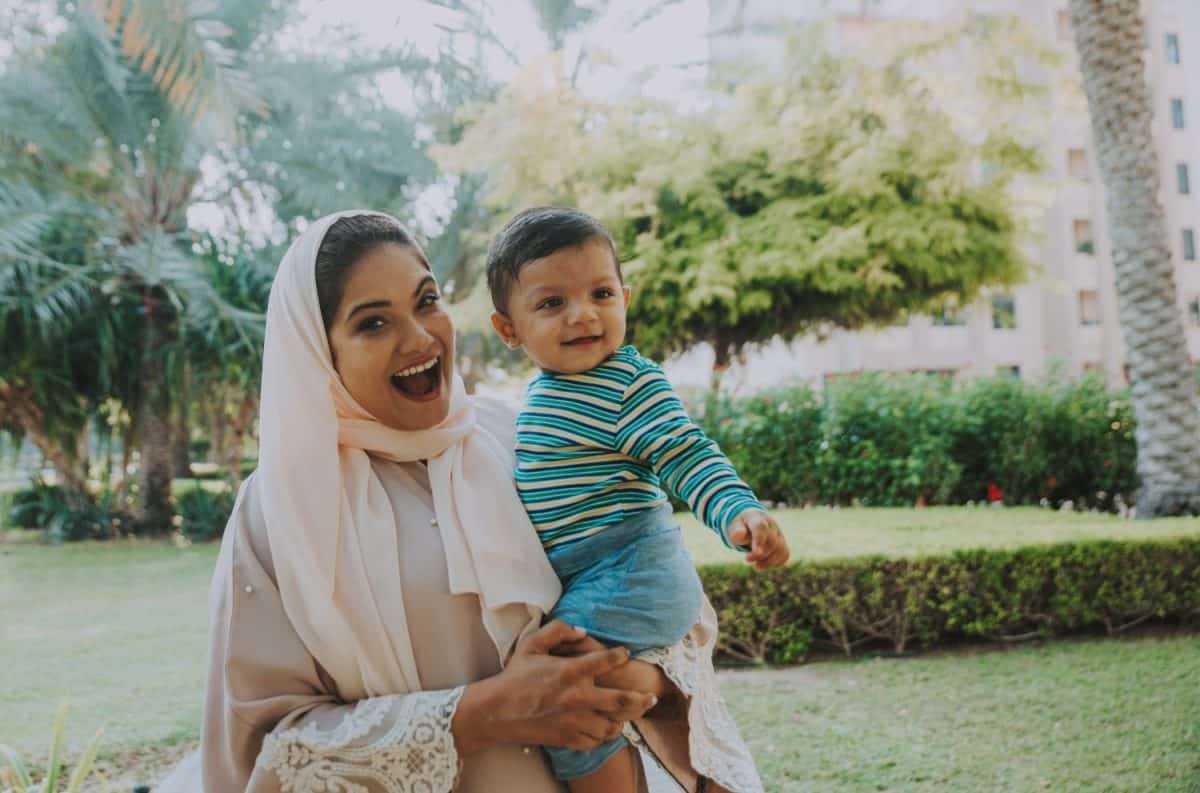 Happy lifestyle moments. Mom and his baby enjoying time in Dubai outdoor in a park.