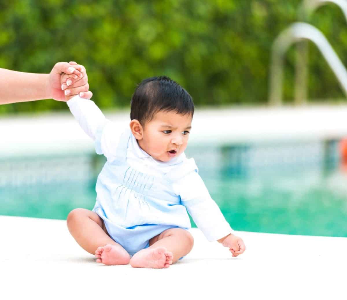 baby boy on the background of the pool