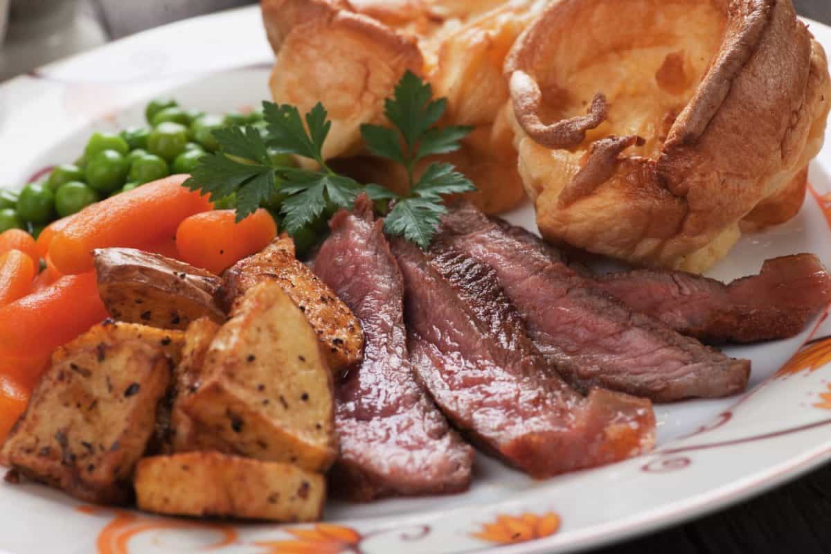 Traditional british sunday roast with yorkshire pudding, roasted potato and vegetables. household routine