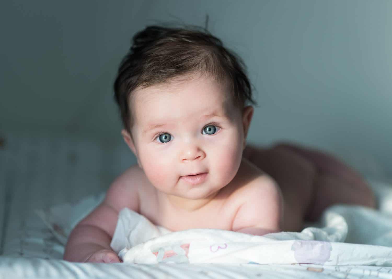 cute baby with dark hair lying