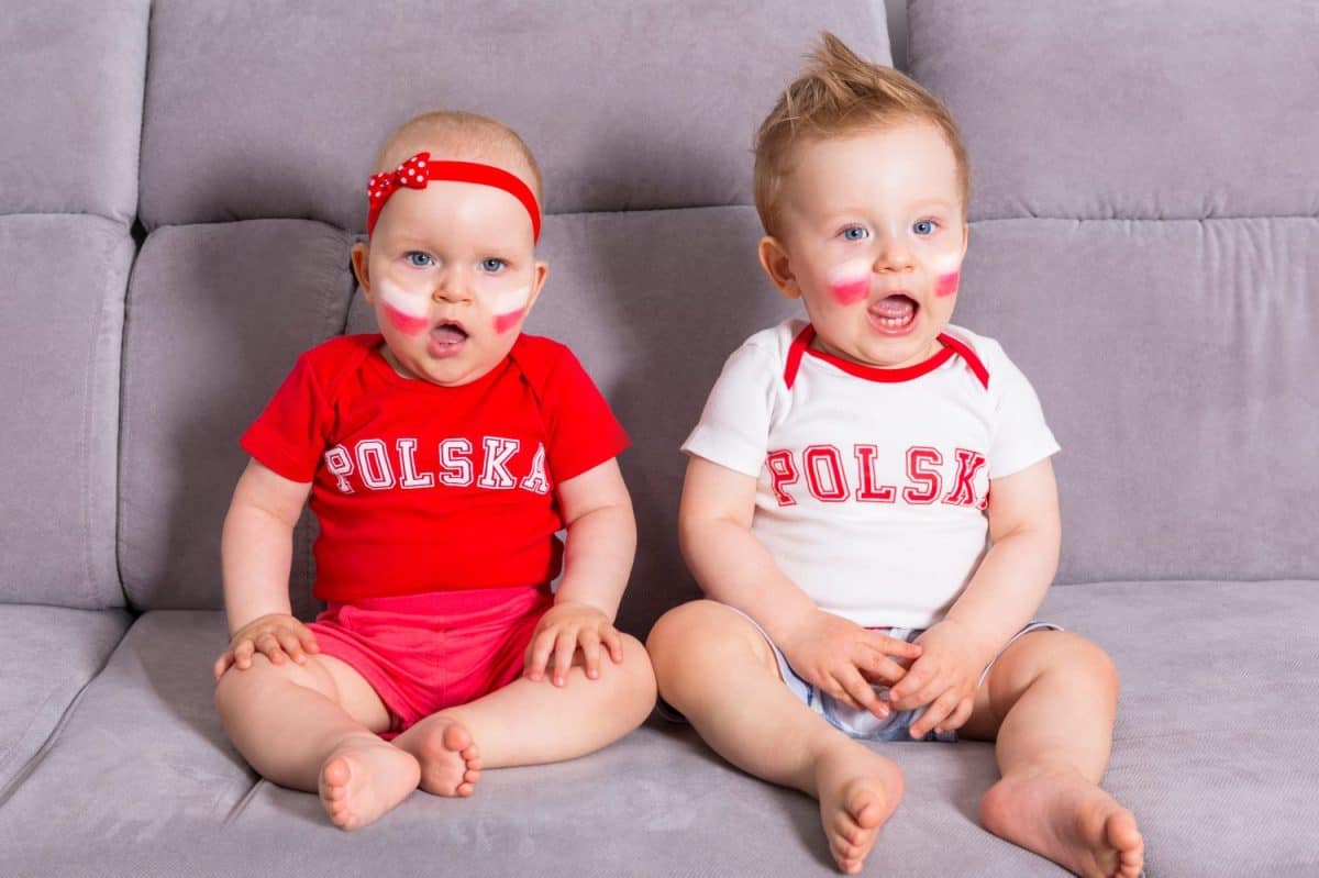 Soccer baby twins fans of Poland team in national colors