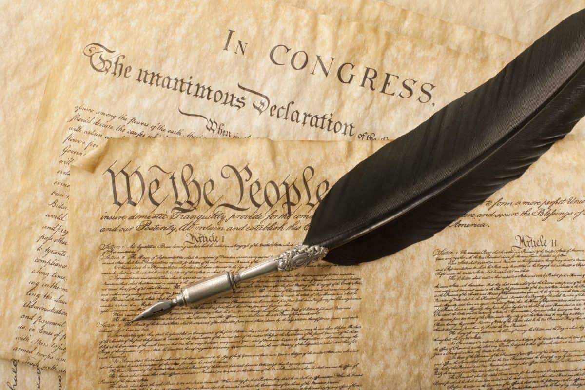 The Constitution for the United States of America with a quill pen