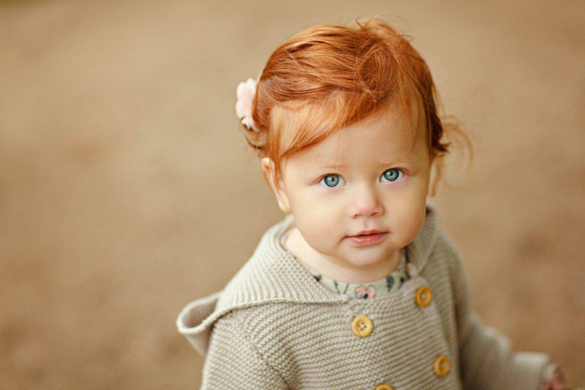 Red-haired baby girl close-up portrait