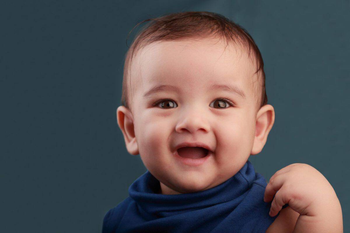 Portrait of a cute baby against a colour background