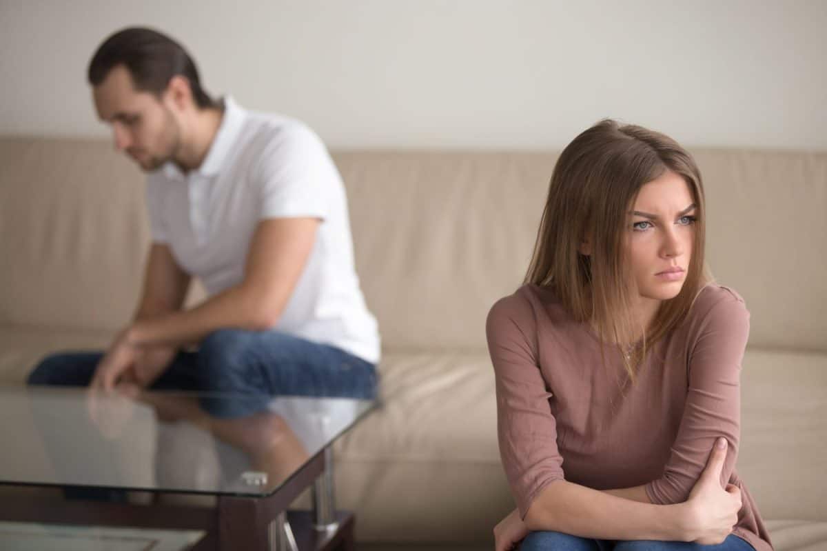 Sad couple not talking to each other after quarrel. Pensive upset woman feeling offended, thinking over problems in relationships, anxious about future, upset man sitting in the background. Signs It May Be Time for a Divorce